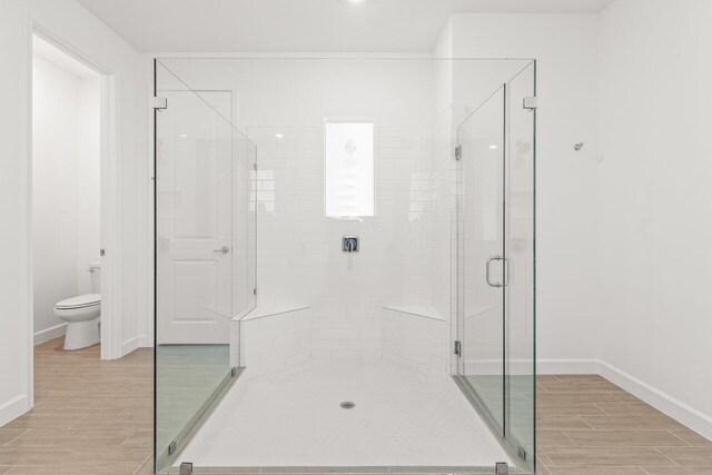 bathroom with vanity and a shower with door