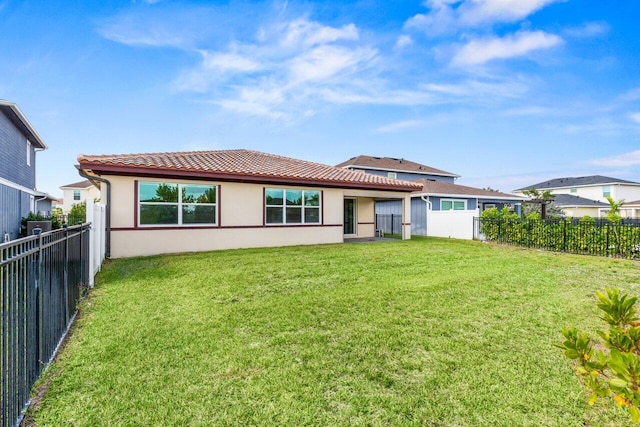 rear view of property with a lawn