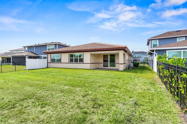 rear view of house featuring a yard