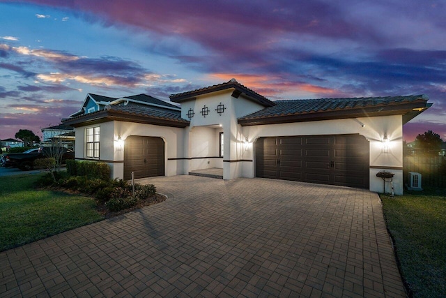 mediterranean / spanish-style home with a garage