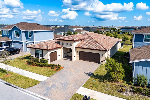 view of front of property with a garage and a front lawn