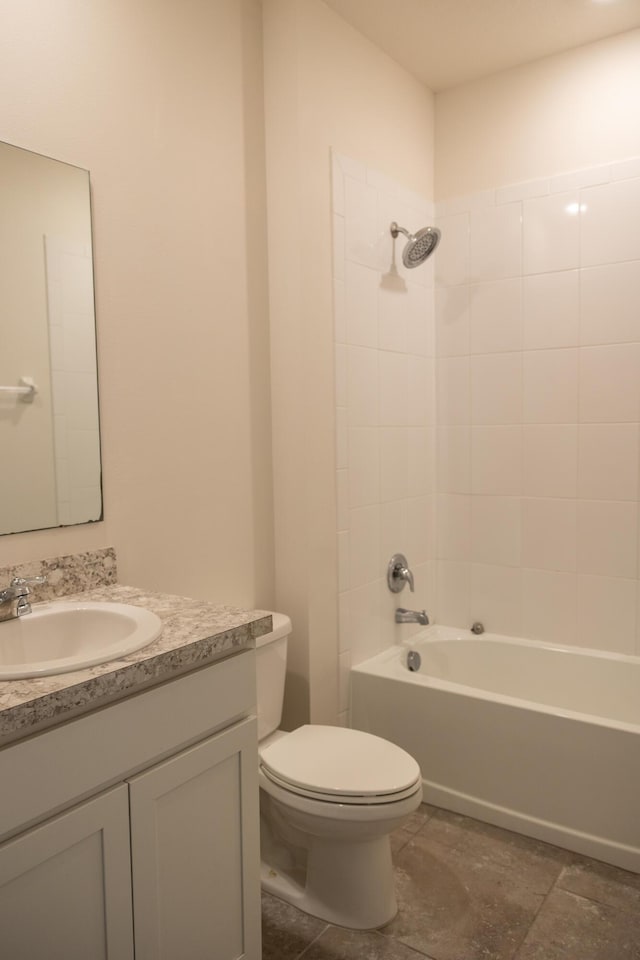 full bathroom with vanity, toilet, and tiled shower / bath