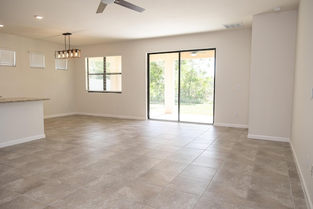 empty room featuring ceiling fan and light tile patterned floors