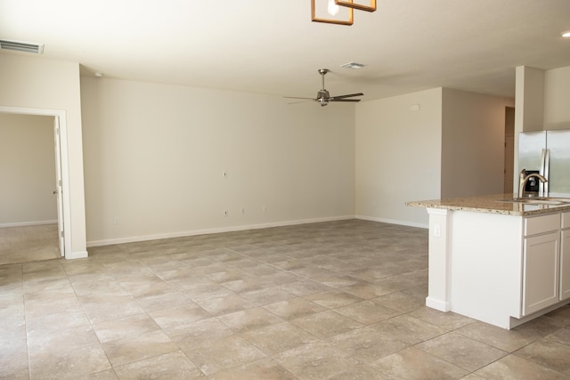 interior space featuring sink and ceiling fan