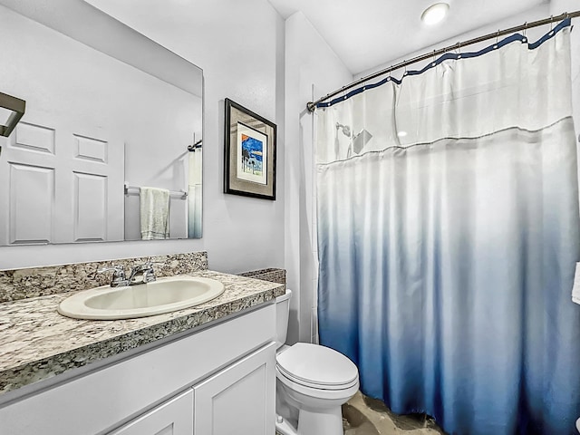 bathroom with vanity, a shower with shower curtain, and toilet