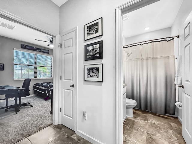 bathroom featuring walk in shower and toilet