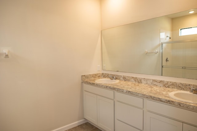 bathroom with vanity and a shower with shower door