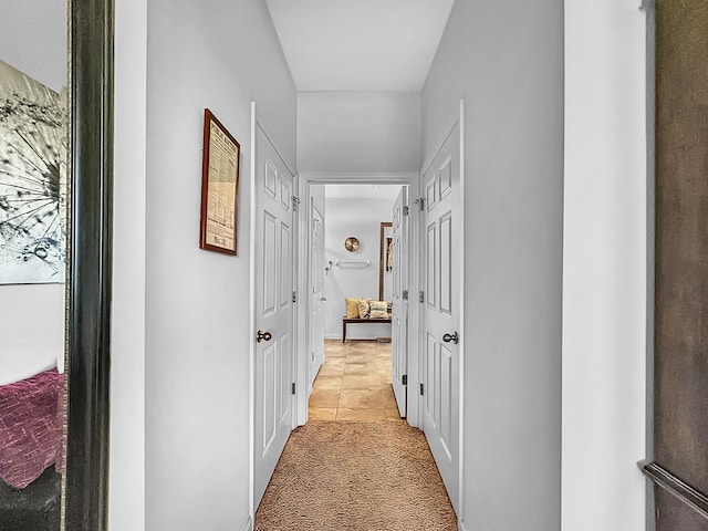 hallway with light colored carpet