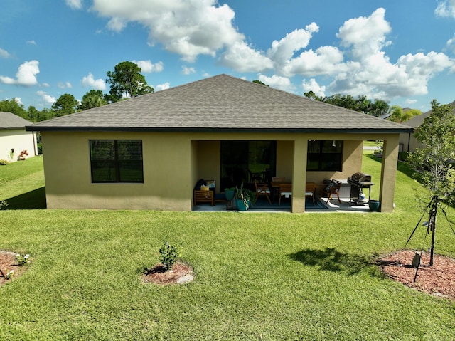 back of house with a patio and a yard