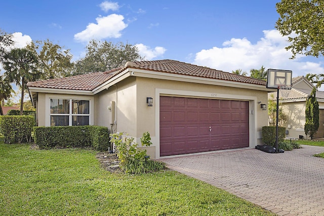 mediterranean / spanish home with a garage and a front lawn