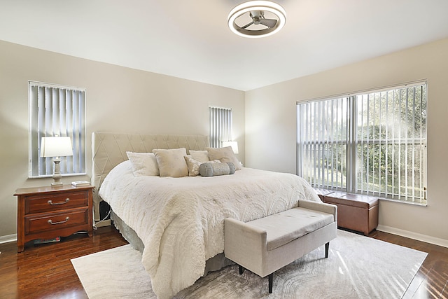 bedroom with dark hardwood / wood-style flooring