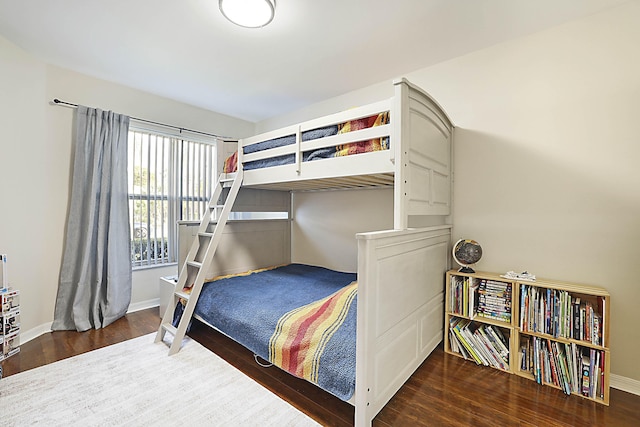 bedroom with dark hardwood / wood-style floors