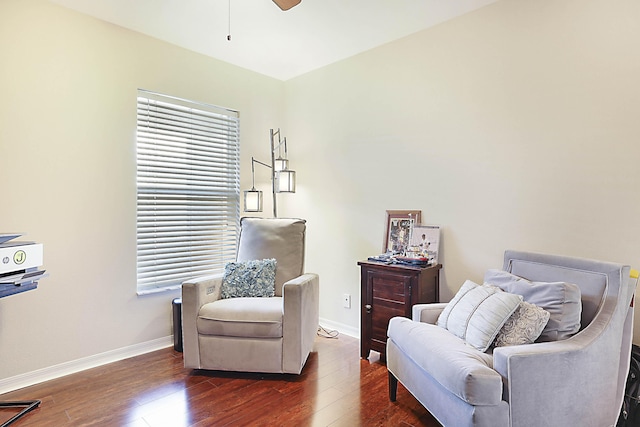 sitting room featuring dark wood-type flooring and ceiling fan