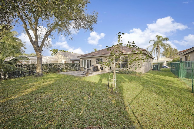 rear view of property with a patio area and a lawn