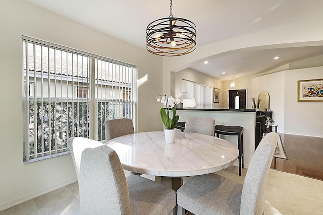 dining space with vaulted ceiling