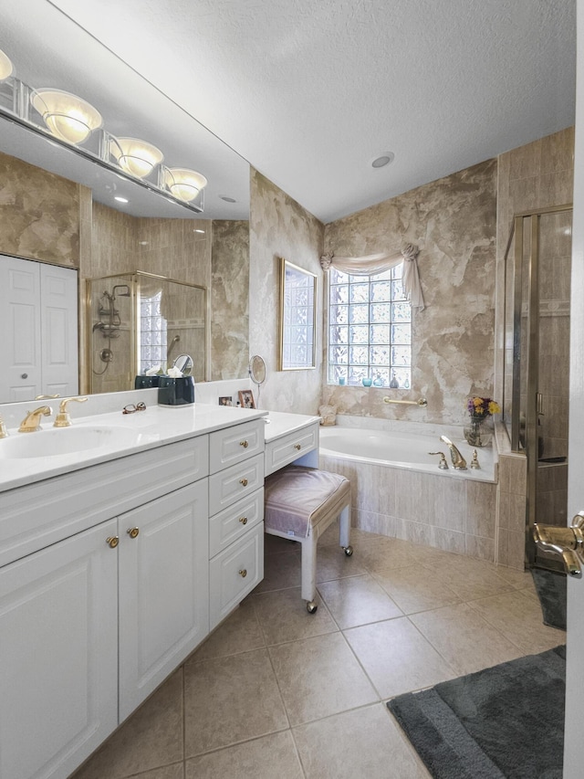 bathroom with vanity, tile patterned floors, shower with separate bathtub, and a textured ceiling