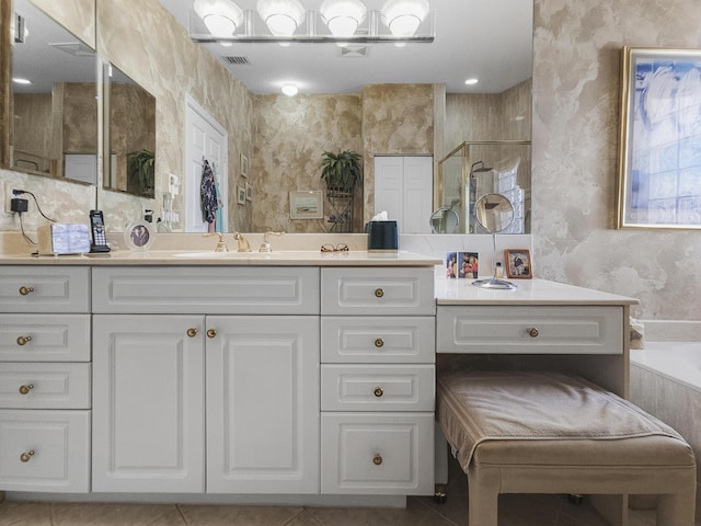 bathroom featuring independent shower and bath, vanity, and tile patterned floors