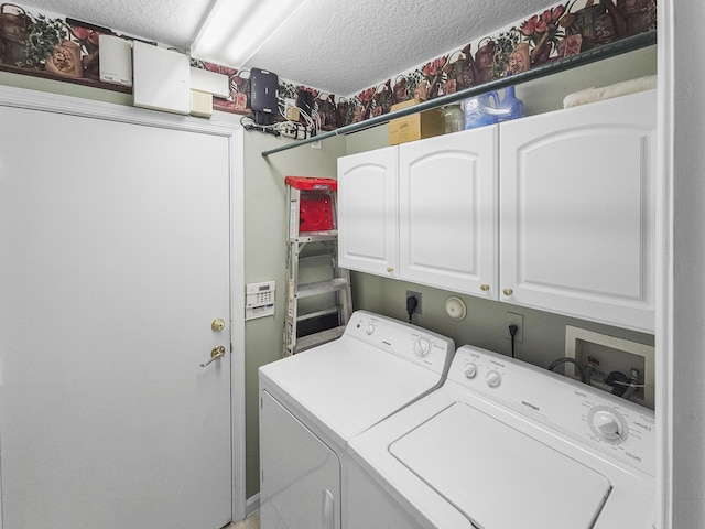 washroom with separate washer and dryer, cabinets, and a textured ceiling