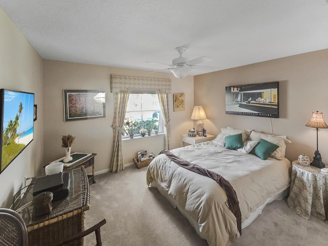 bedroom featuring ceiling fan and light carpet