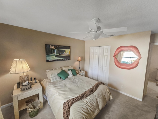 carpeted bedroom featuring a textured ceiling, ceiling fan, and a closet