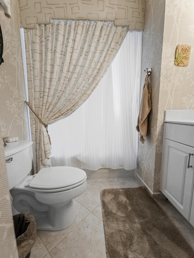 bathroom featuring tile patterned flooring, vanity, and toilet