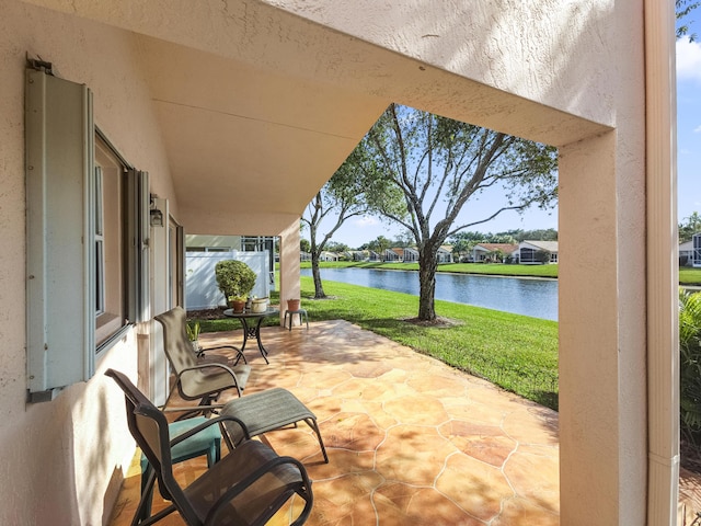 view of patio with a water view