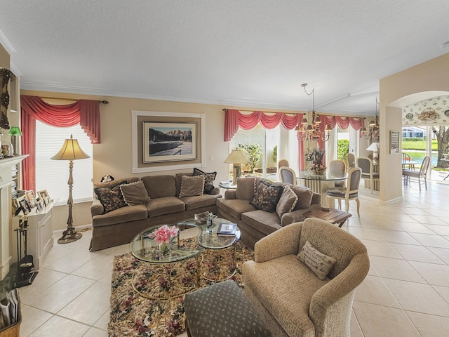 tiled living room featuring ornamental molding, a chandelier, and a textured ceiling