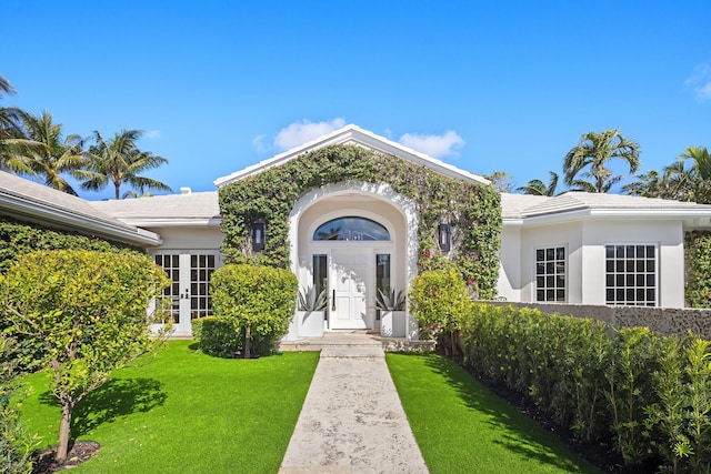 view of front of property featuring french doors and a front yard