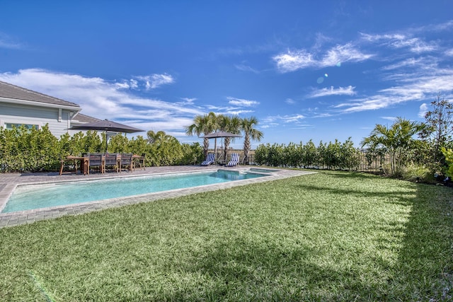 view of pool featuring a lawn