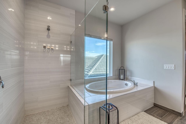 bathroom featuring separate shower and tub