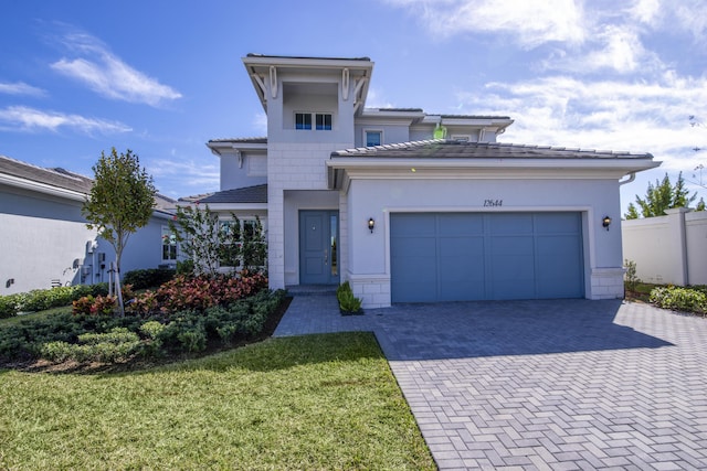 view of front of home featuring a garage and a front lawn