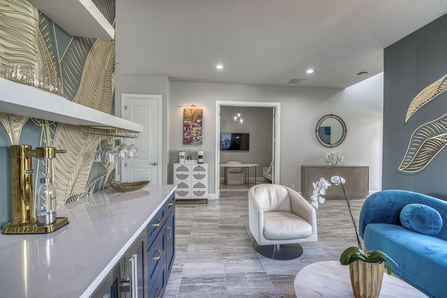 interior space with blue cabinetry and light stone counters