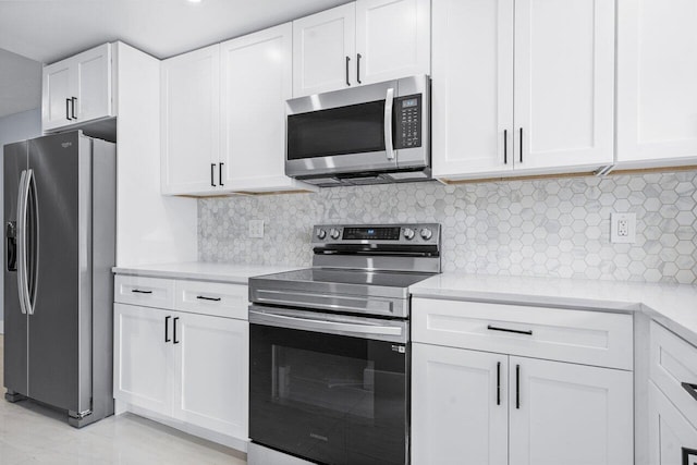 kitchen featuring stainless steel appliances, white cabinetry, and tasteful backsplash