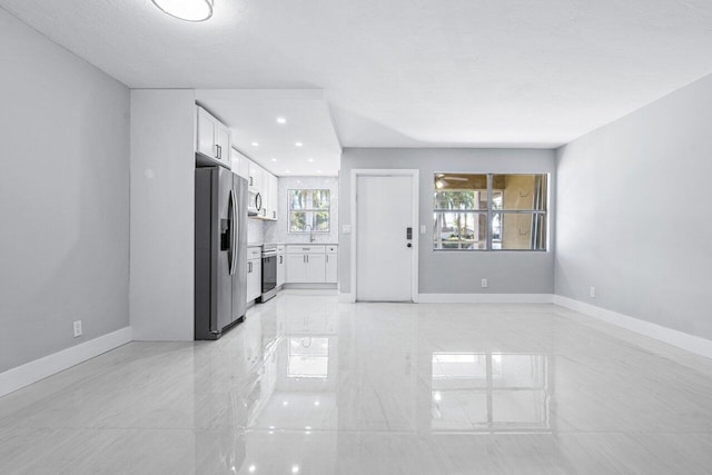 unfurnished living room with sink