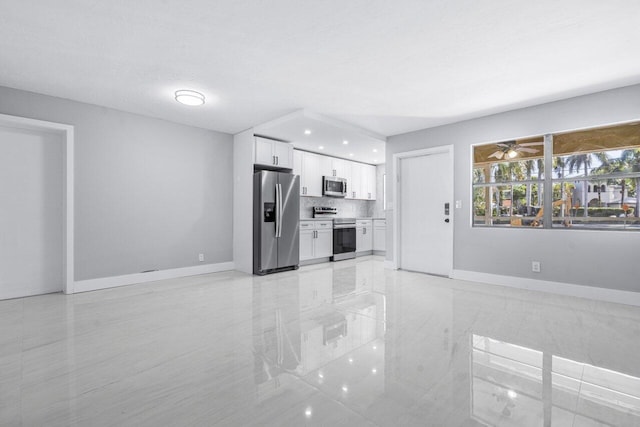 unfurnished living room featuring ceiling fan