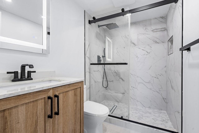 bathroom with walk in shower, vanity, and toilet