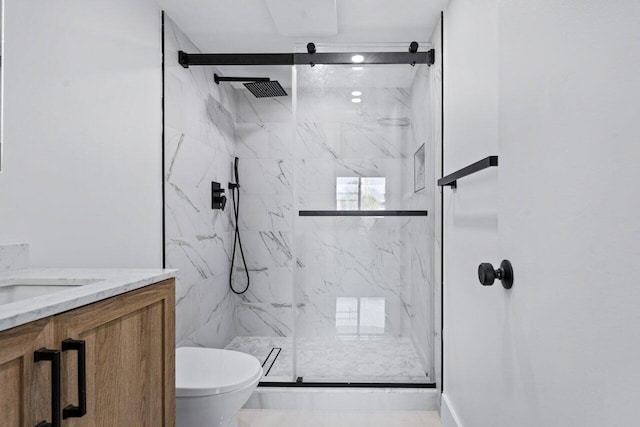 bathroom featuring walk in shower, vanity, and toilet