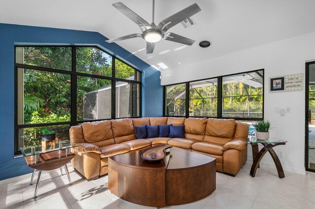 living room with light tile patterned floors, vaulted ceiling, and ceiling fan