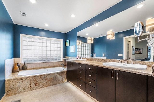 bathroom featuring vanity, tile patterned floors, and tiled bath