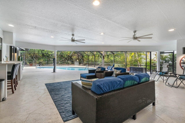 view of patio with an outdoor living space, a lanai, an outdoor bar, and ceiling fan