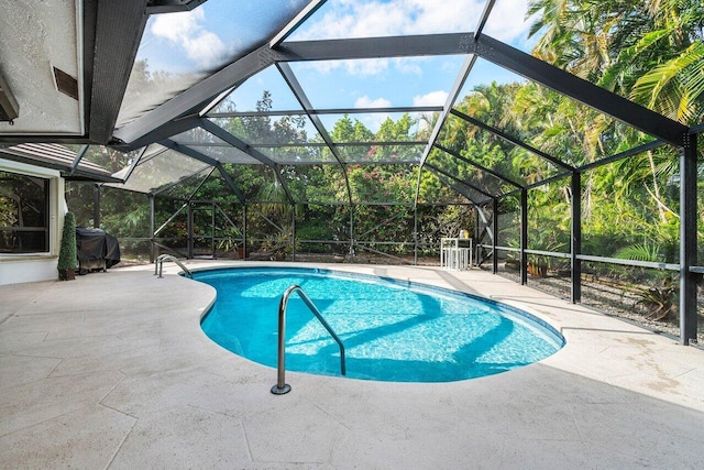 view of swimming pool with a patio and glass enclosure