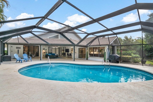 view of swimming pool featuring a patio area and glass enclosure