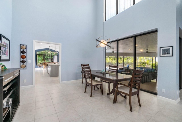 dining space with a high ceiling and light tile patterned floors