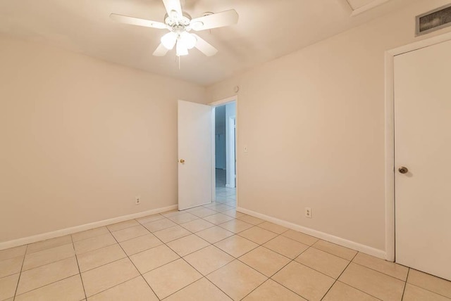 unfurnished room with light tile patterned floors and ceiling fan