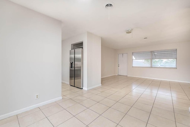 spare room featuring light tile patterned floors