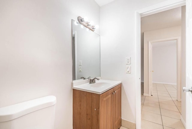 bathroom with vanity, tile patterned floors, and toilet