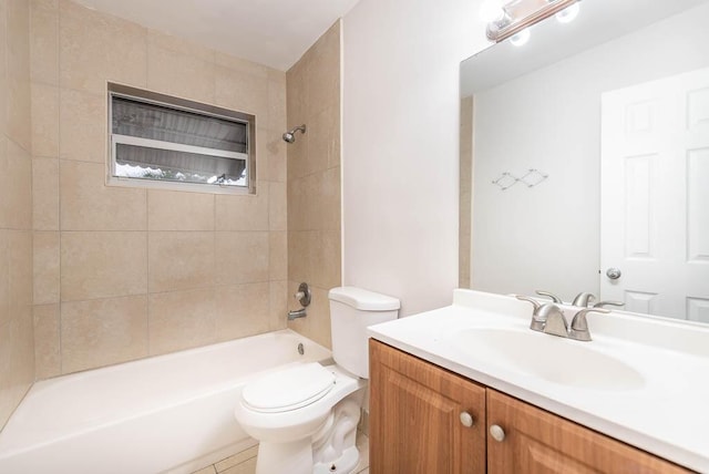 full bathroom featuring tiled shower / bath combo, vanity, and toilet