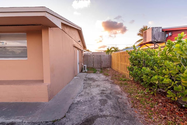 property exterior at dusk featuring central AC