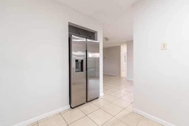 kitchen with stainless steel refrigerator with ice dispenser and light tile patterned flooring