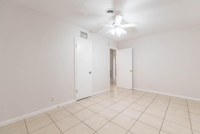 empty room featuring light tile patterned flooring and ceiling fan